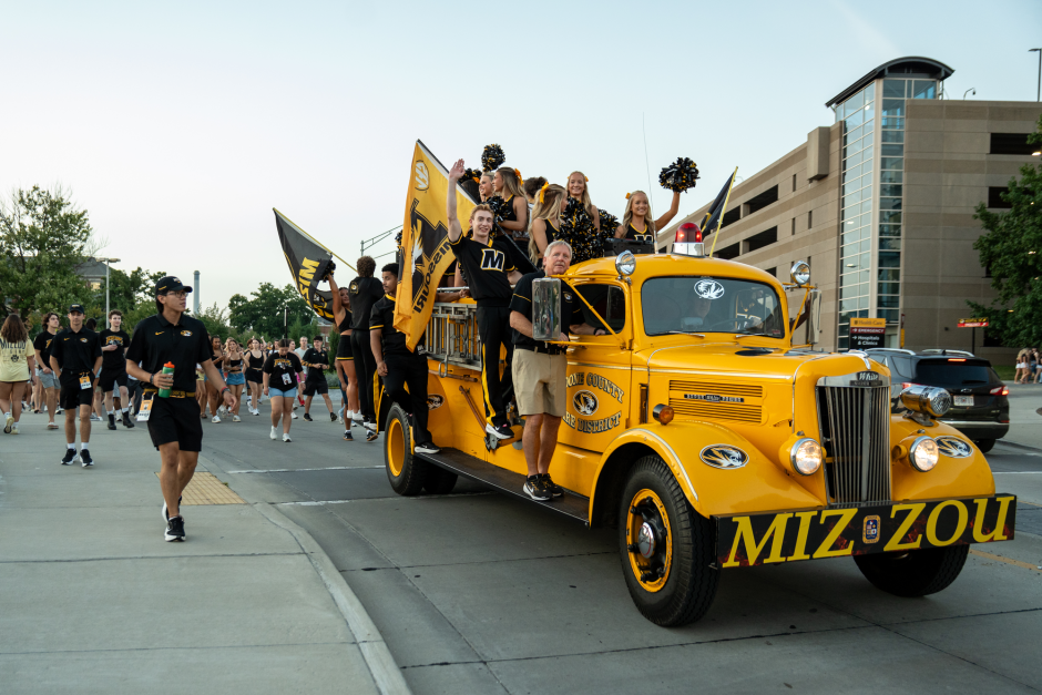 Gold truck carrying students