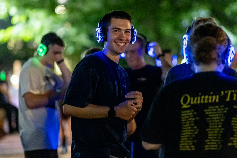 A student with earphones dances