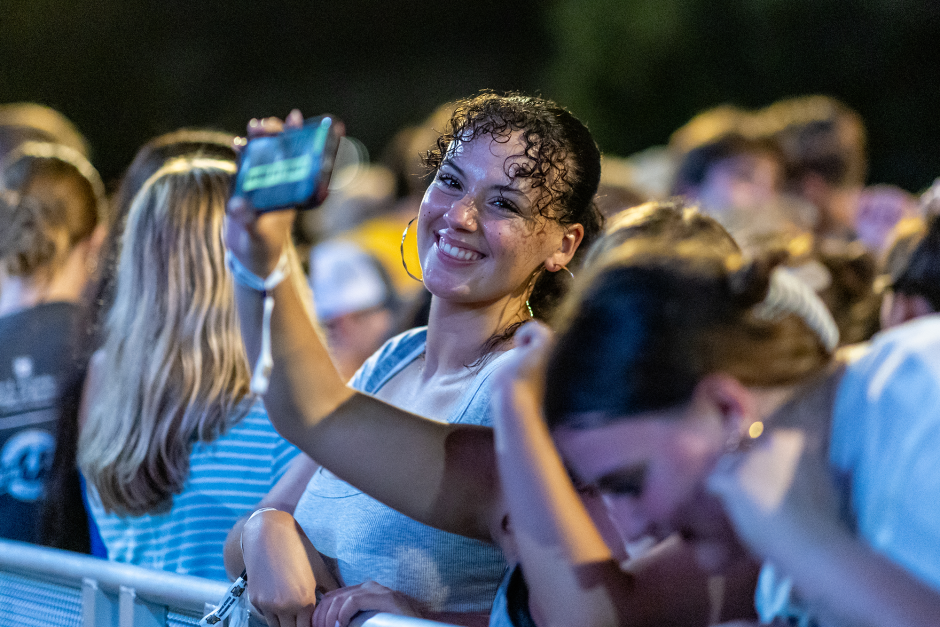 A student in a crowd smiles