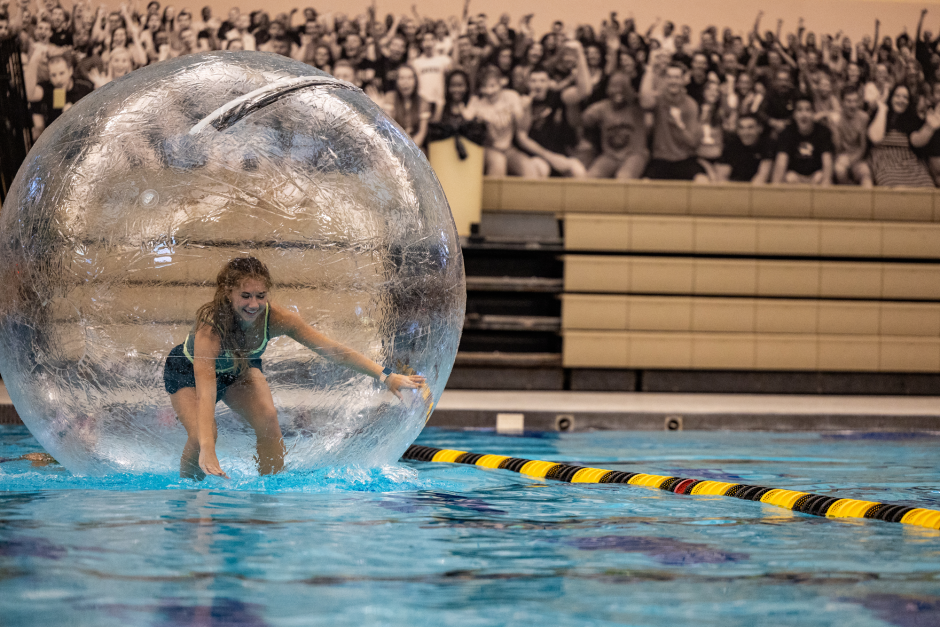 A student in a bubble in a pool