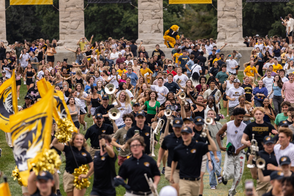 Students run through columns