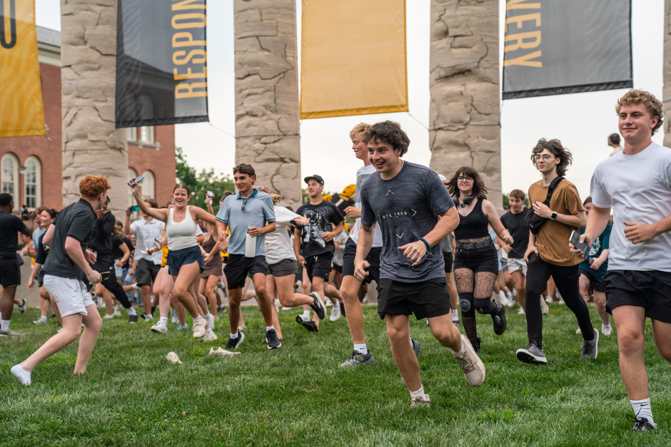 Students run through Columns