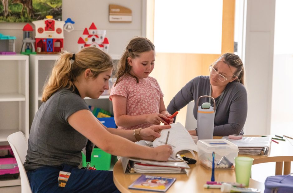 Thompson Center staff work with a young girl