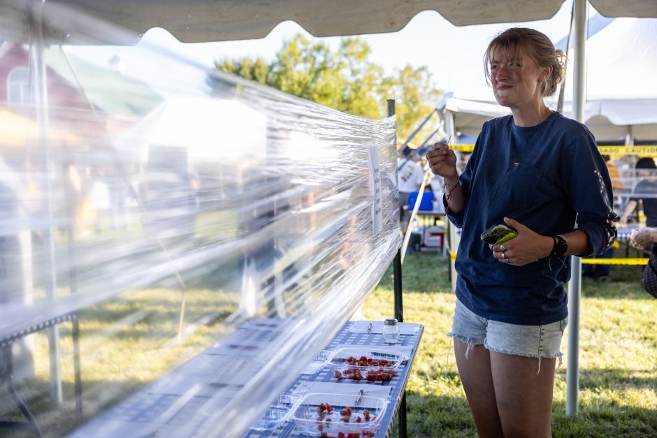 Mary Davison tries at tomato at the tomato festival