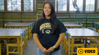 Student in library with video button