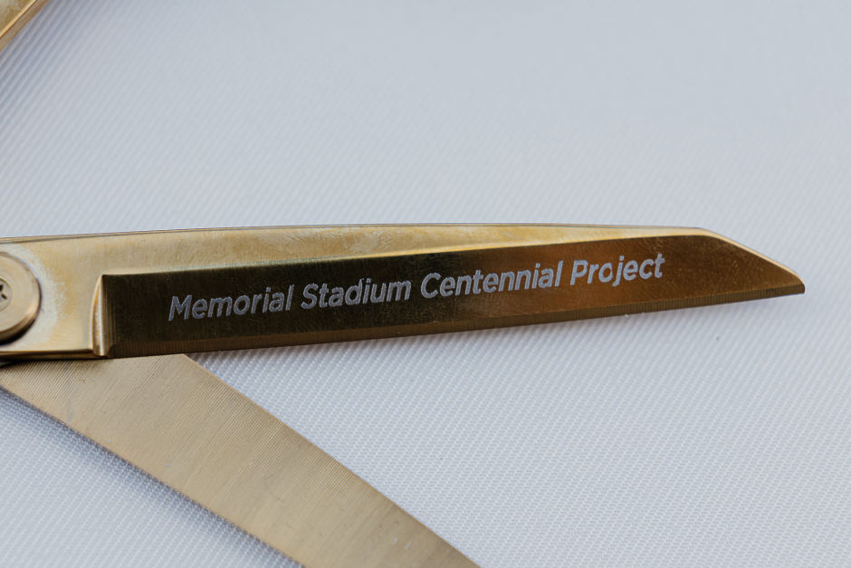 Gold scissors inscribed with Memorial Stadium Centennial Project