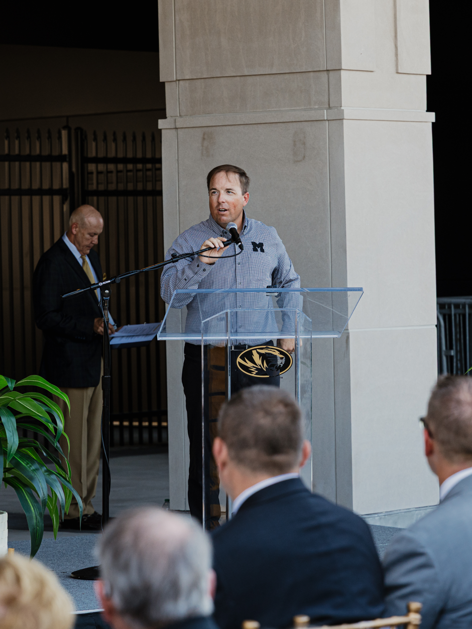 Coach Drinkwitz at podium