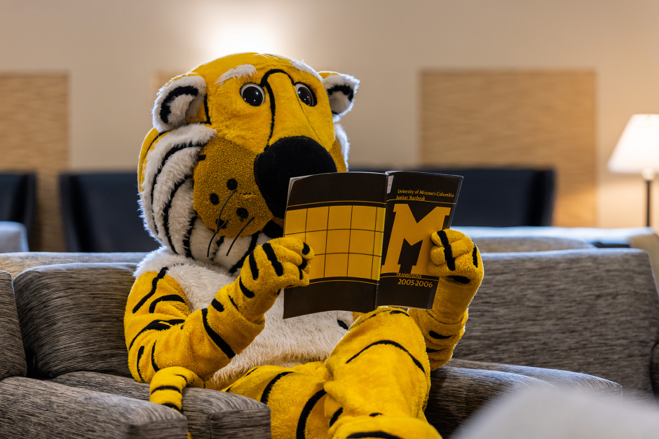 Truman looks at yearbook