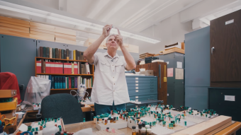 Bob Sites looks at an insect specimen in a lab
