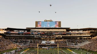 Newly renovated north end zone during the national anthem before the first home football game of the 2026 season with a military helicopter flyover