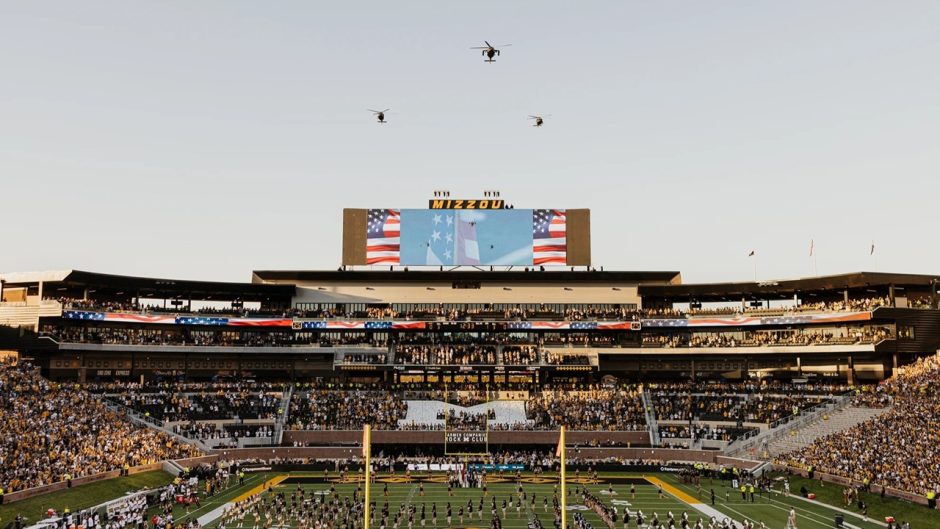 Newly renovated north end zone during the national anthem before the first home football game of the 2026 season with a military helicopter flyover