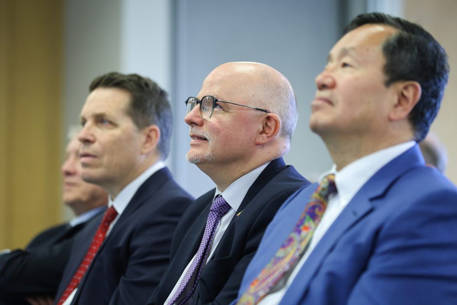 Three men sitting in a row