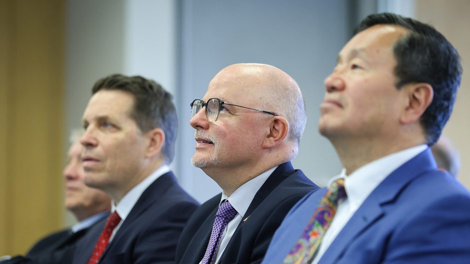 Three men sitting in a row