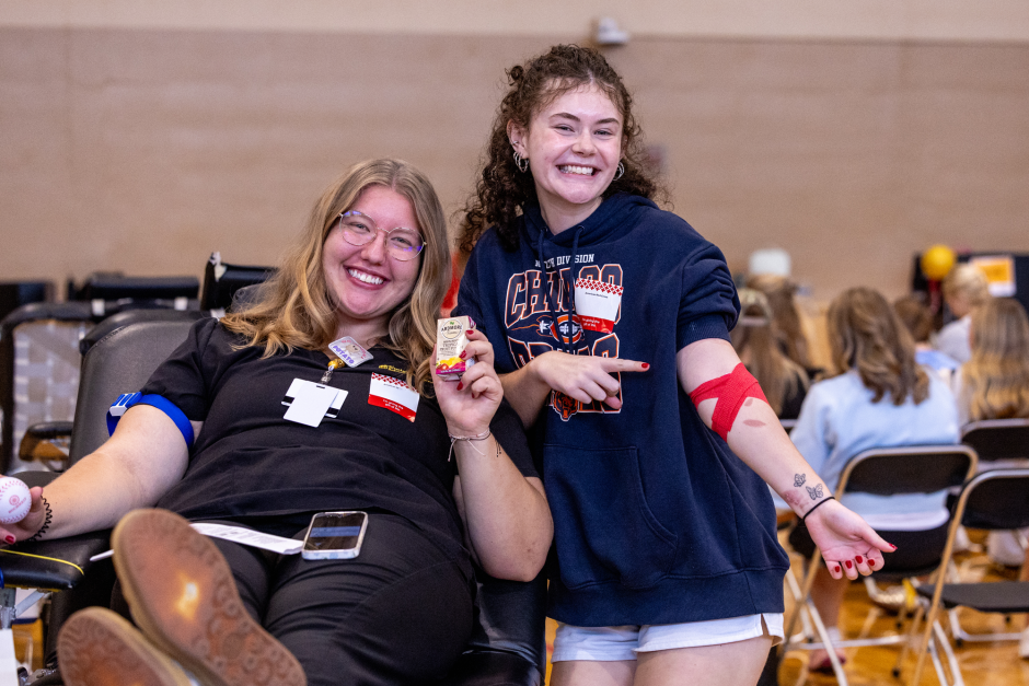Two students smile after giving blood