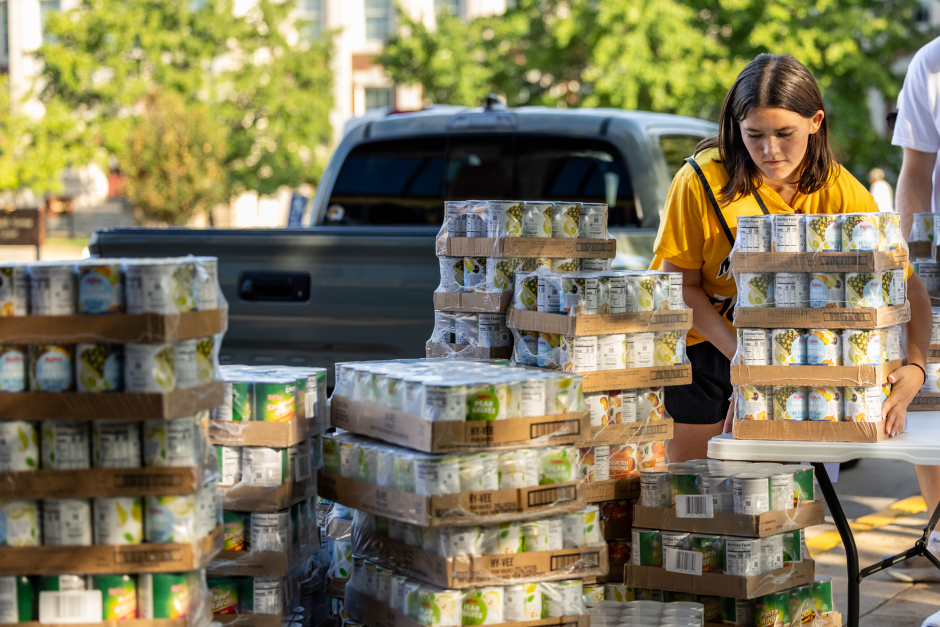 Student stacks boxes of cans