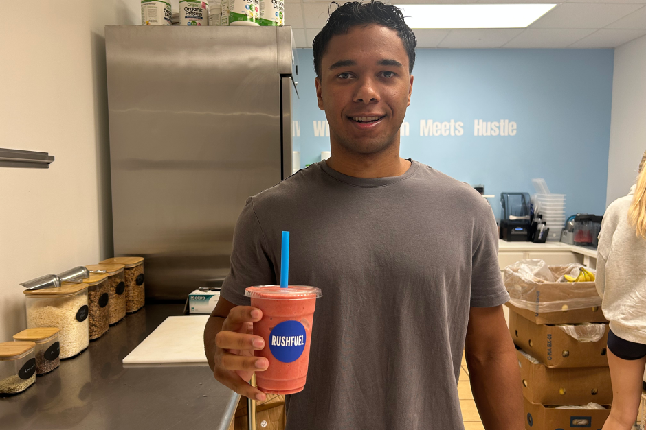 A student posing in his retail shop.