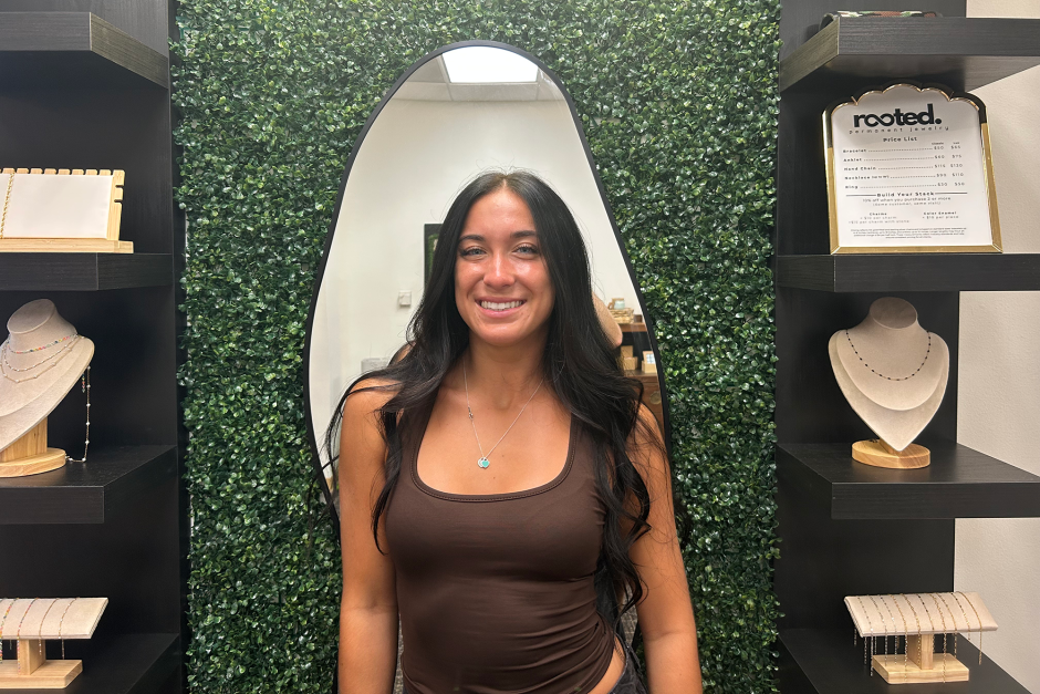 A student posing in her retail shop.
