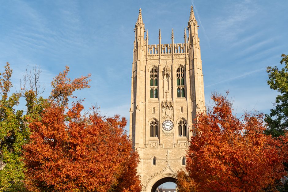 Memorial Union tower surrounded by autumn-colored tress.
