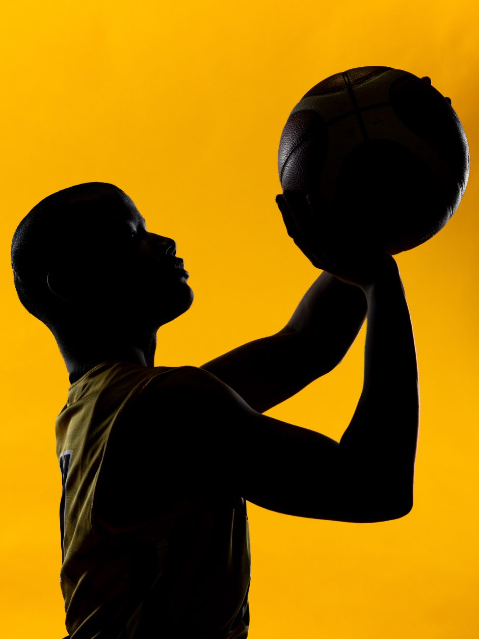 Silhouette of a basketball player preparing to shoot a shot
