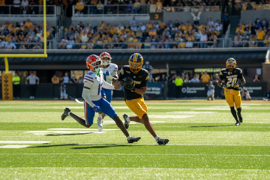 Mizzou football player evading a defender