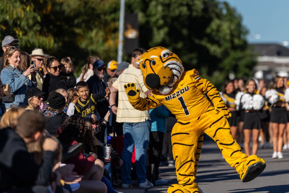 Truman the Tiger waving at children