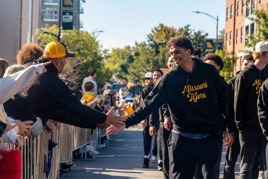 Mizzou Tiger player giving a handshake to a fan