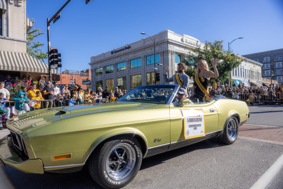 Convertible with people sitting on the back in the Homecoming parade