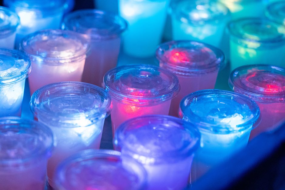 Different colored lights shining through drink cups