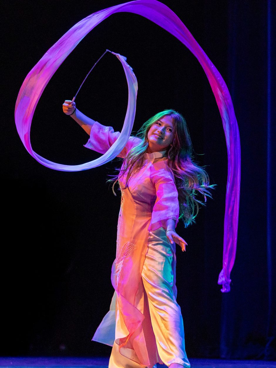 A performer on stage twirling a ribbon