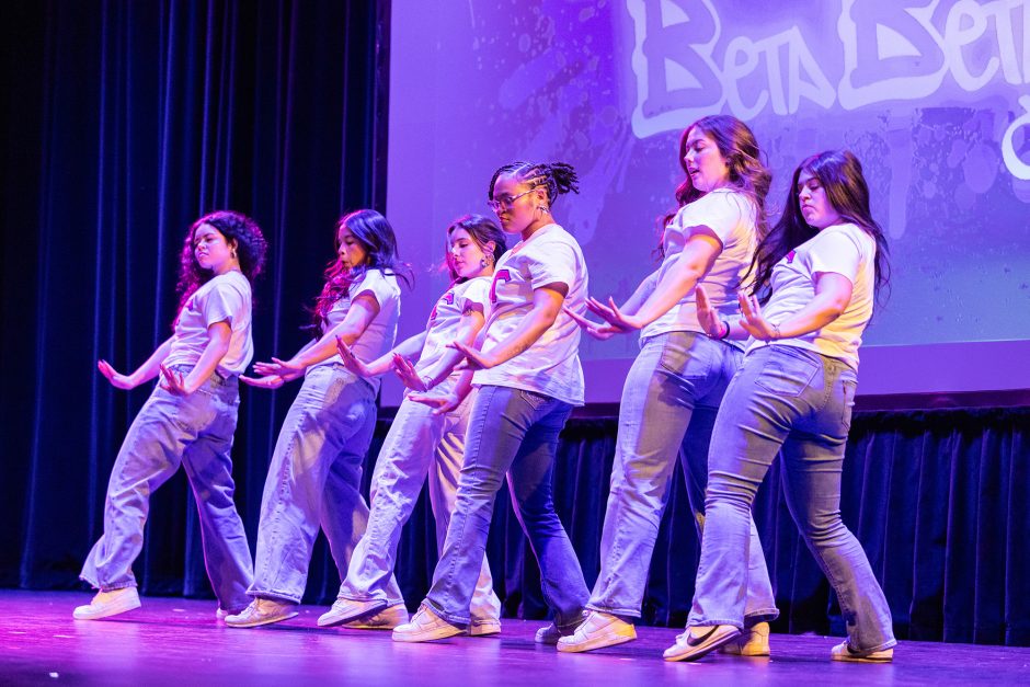 Six students dance on stage 