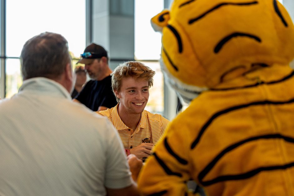 Student sitting at a table with Truman the Tiger